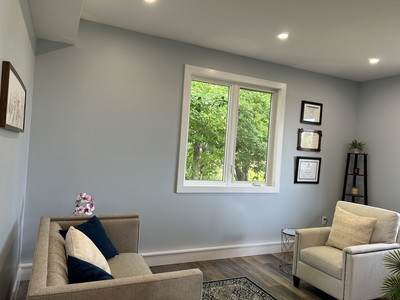 inside the office showcasing the large windows near the client and therapist seating